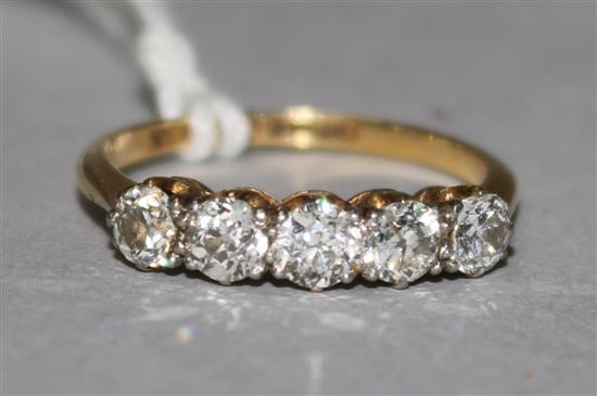 An 18ct gold and platinum five stone half hoop diamond ring, size M.